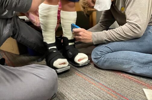 photo of a therapist at Westside Children's Therapy in Illinois with a child that has serial casting