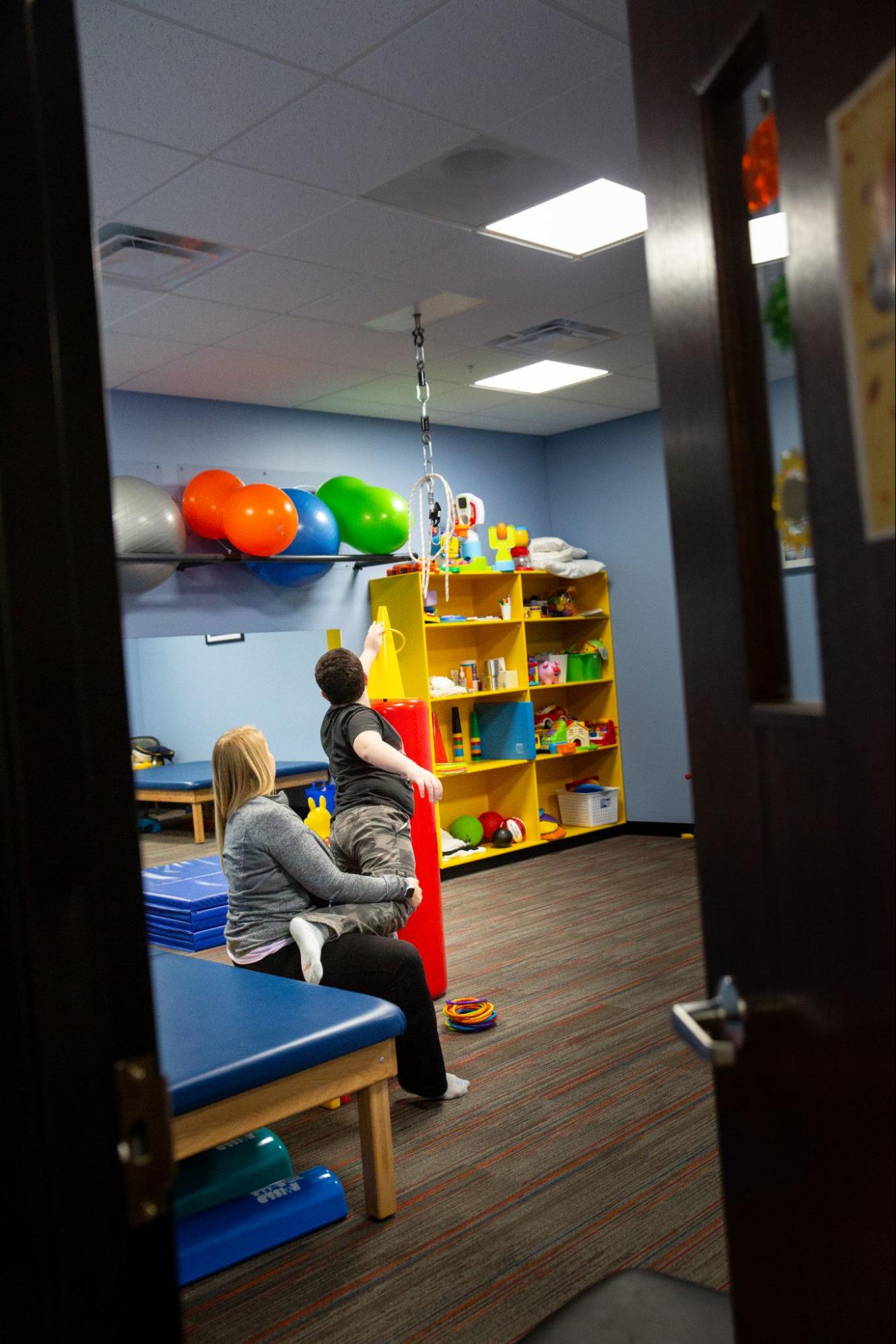photo of a child and therapist during a physical therapy session at Westside in Illinois