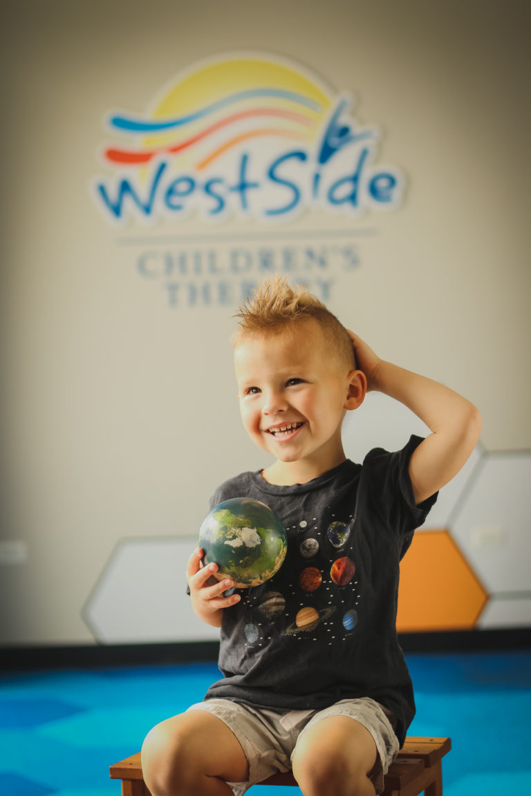 photo of a child smiling in the Westside Children's Therapy clinic in Illinois, the lobby