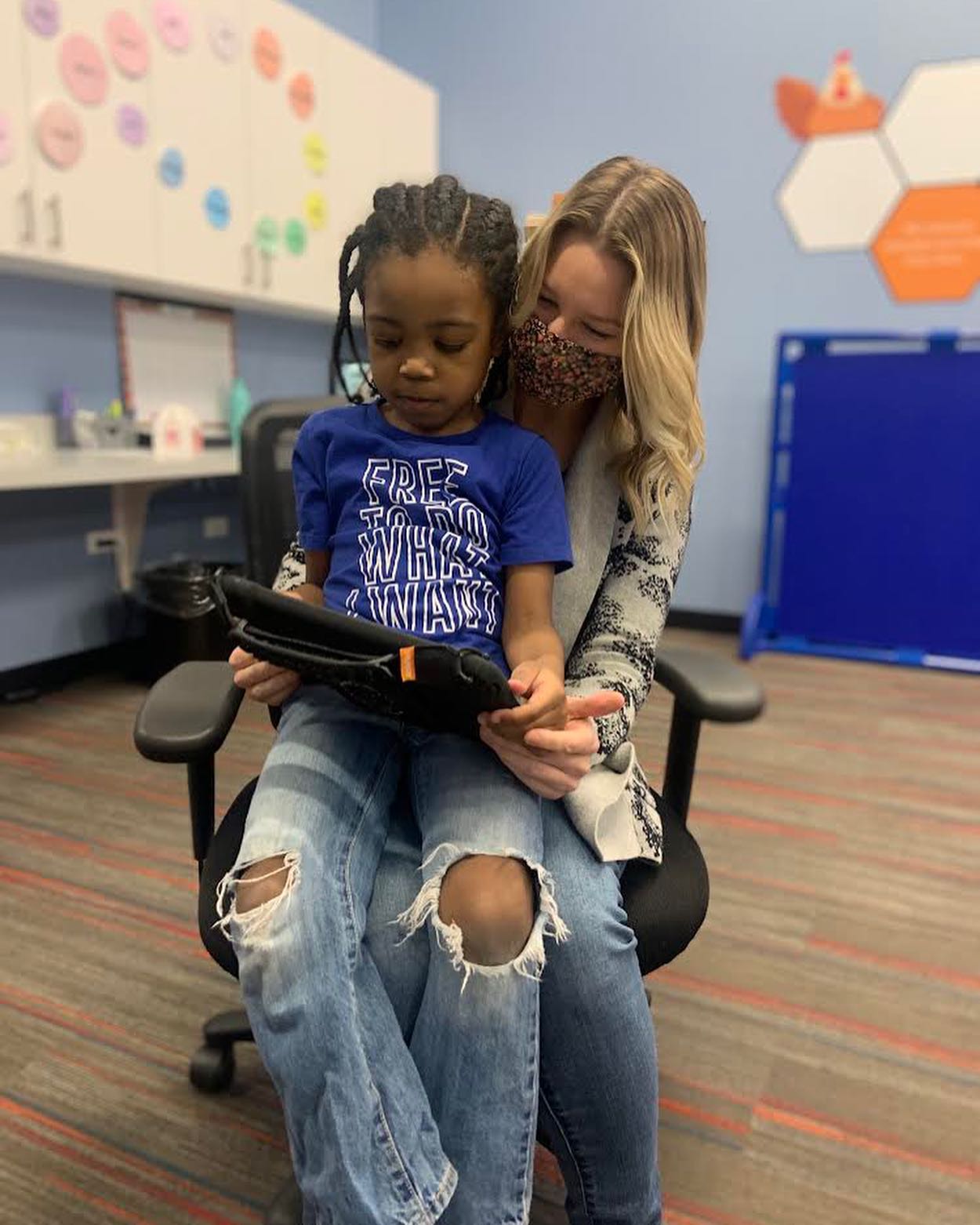 child and therapist working with an AAC device at Westside Children's Therapy in Illinois