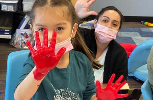 kid and therapist during a painting session for kids occupational therapy