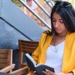 Mother reading book by coffee shop