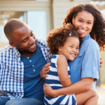 A happy family with a young child enjoying time outdoors together at a sensory-friendly community event near Chicago.