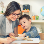 A therapist working one-on-one with a young child during an ABA therapy session in a pediatric clinic.