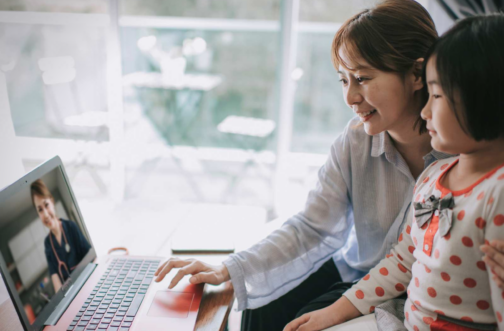 Mother and daughter meeting with a clinician on a laptop during a virtual autism evaluation