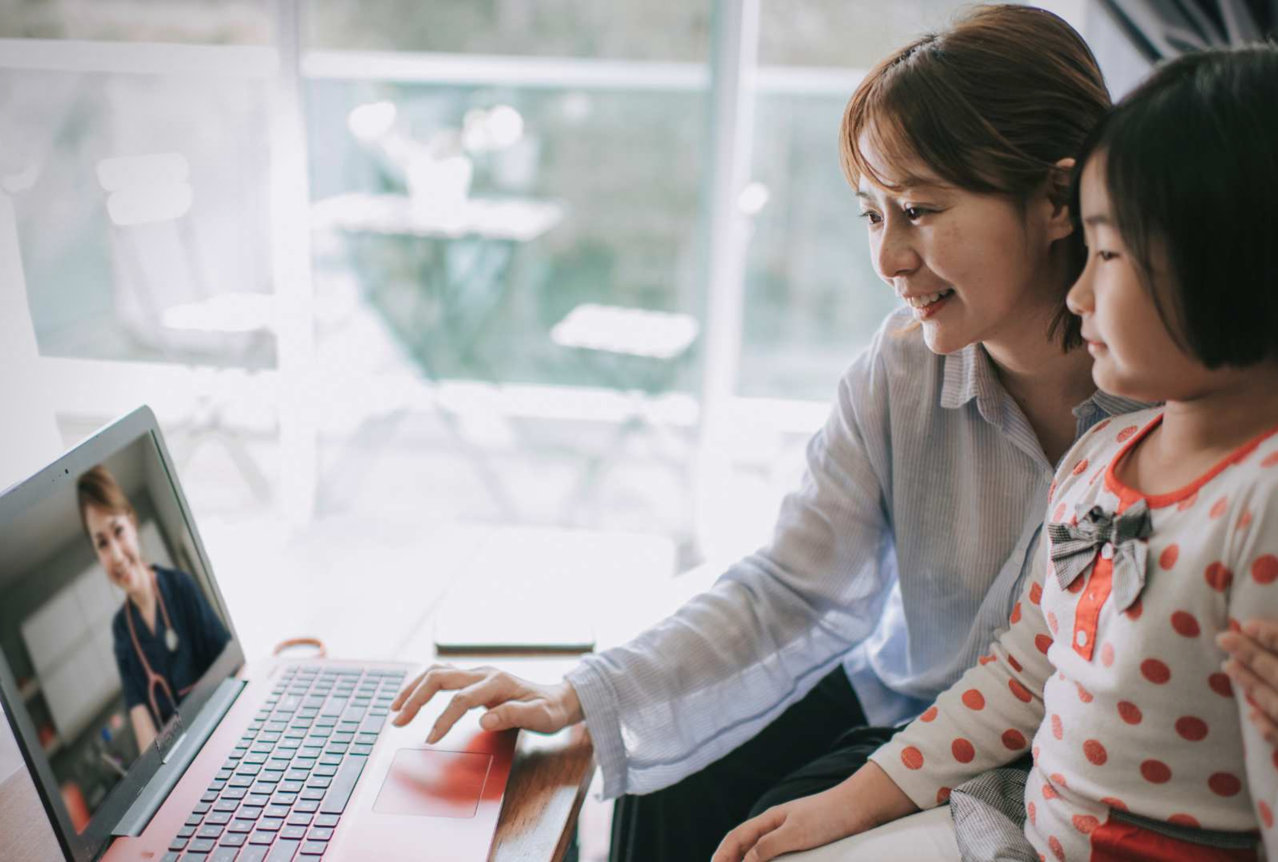 Mother and daughter meeting with a clinician on a laptop during a virtual autism evaluation