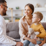 Clinician talking with a mother and young son about autism evaluation options