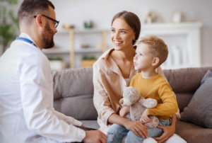Clinician talking with a mother and young son about autism evaluation options