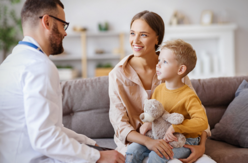 Clinician talking with a mother and young son about autism evaluation options