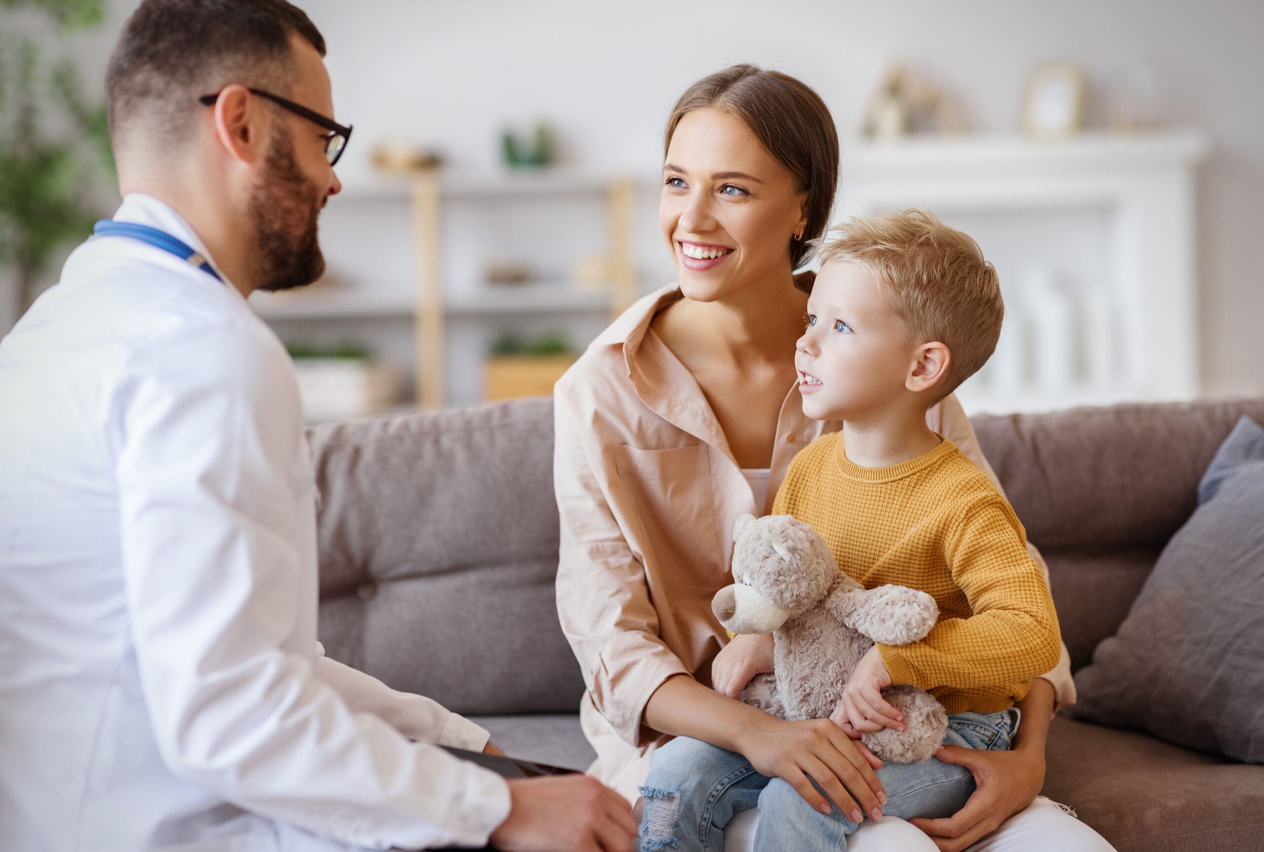 Clinician talking with a mother and young son about autism evaluation options
