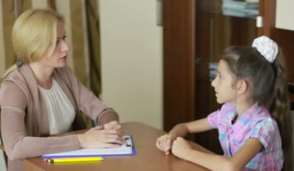 photo of a child with a therapist during counseling. This photo is used for the How To Know If Your Child Needs Counseling blog article.